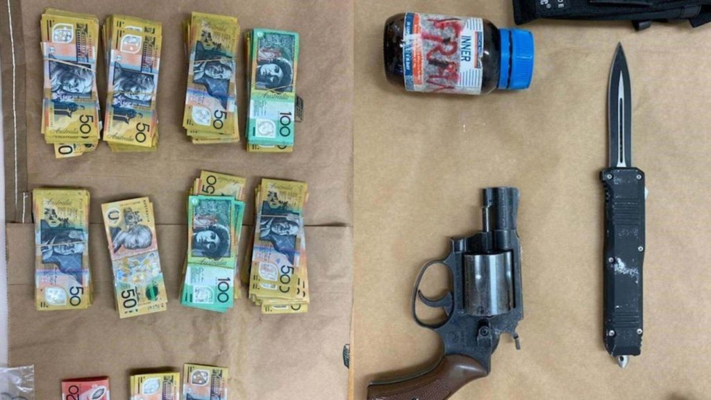 Man found knocked out on road after crash with $83k in cash, loaded gun and drugs, police say