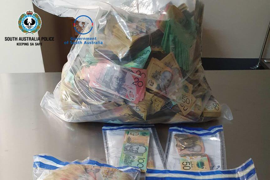 Almost a million dollars in cash, drugs found by police in Adelaide hotel room